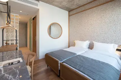a bedroom with a large bed and a mirror at Ergon House Athens in Athens