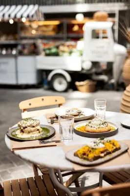 a table with plates of food on top of it at Ergon House Athens in Athens