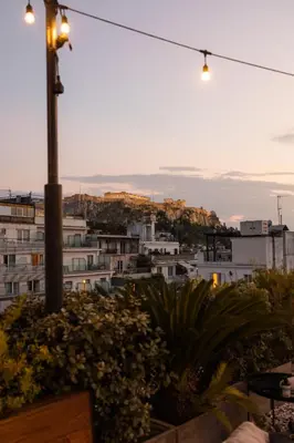 a city skyline with a street light and buildings at Ergon House Athens in Athens