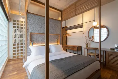 a bedroom with a large bed and a desk at Ergon House Athens in Athens