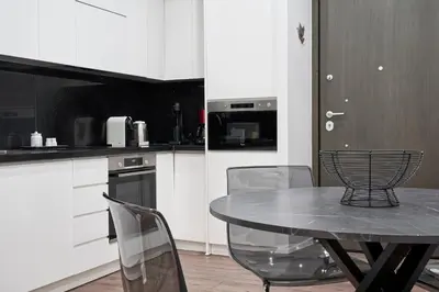 a kitchen with a table and chairs in a kitchen at Valaoritou Boutique Apartment,Kolonaki in Athens