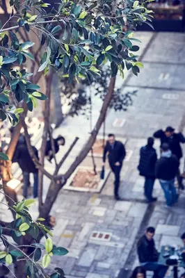 a group of people walking down a city street at Valaoritou Boutique Apartment,Kolonaki in Athens