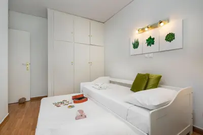 a white living room with a white couch at Secret Aktis by BluPine in Athens