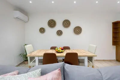 a dining room table with a bowl of fruit on it at Secret Aktis by BluPine in Athens