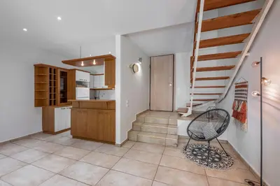 a room with a staircase and a chair at Secret Aktis by BluPine in Athens