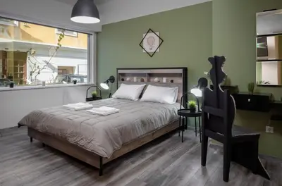 a bedroom with a bed and a chair at Autonomous house in the heart of Plaka in Athens