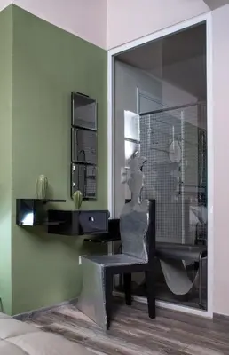 a statue sitting in a chair in a room at Autonomous house in the heart of Plaka in Athens