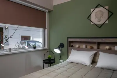 a bedroom with a large bed and a window at Autonomous house in the heart of Plaka in Athens