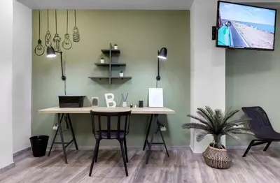 a desk in a room with a tv on a wall at Autonomous house in the heart of Plaka in Athens