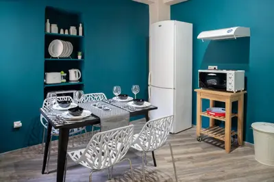 a dining room with a table and chairs and a refrigerator at Autonomous house in the heart of Plaka in Athens