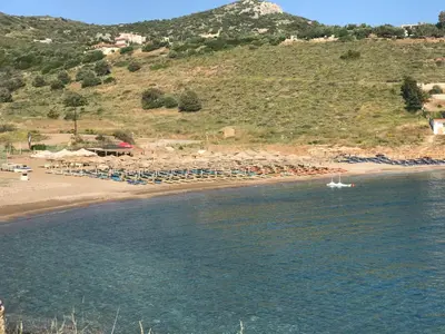 a boat in the water next to a beach at MOTEL KATERINA in Keratea