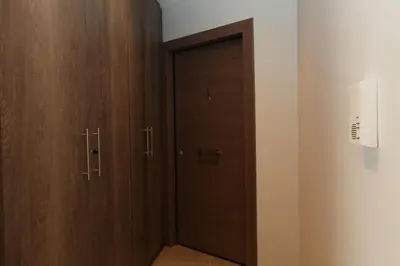 a closet with wooden doors in a room at Edem Beach Apartment with Sea View by Athenian Homes in Athens