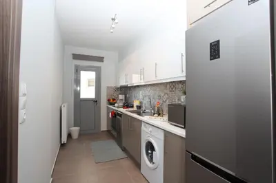 a kitchen with a washer and dryer in it at Edem Beach Apartment with Mountain View by Athenian Homes in Athens