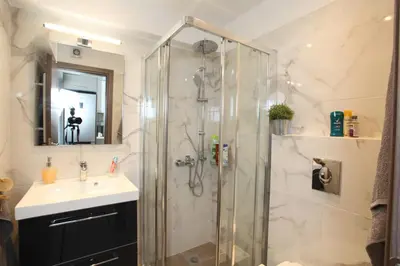a bathroom with a shower and a sink at Edem Beach Apartment with Mountain View by Athenian Homes in Athens