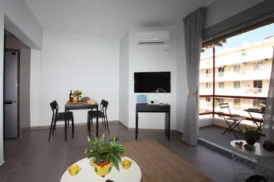 a living room with a table and a dining room at Edem Beach Apartment with Mountain View by Athenian Homes in Athens