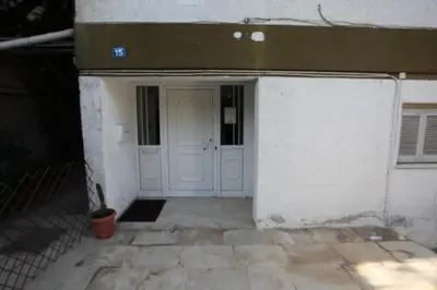 an entrance to a building with a white door at Edem Beach Apartment with Mountain View by Athenian Homes in Athens