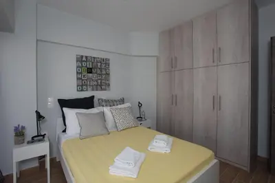 a bedroom with a bed with two towels on it at Edem Beach Apartment with Mountain View by Athenian Homes in Athens