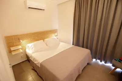 a bedroom with a white bed in a room at Seaside Renovated Top Floor Apartment in Saronida