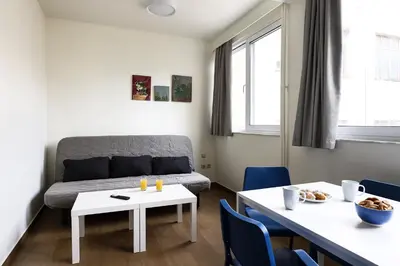 a living room with a couch and a table at MADONAS HOUSE PSIRI in Athens
