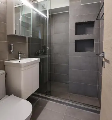 a bathroom with a shower and a toilet and a sink at MADONAS HOUSE PSIRI in Athens