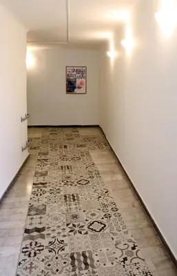 an empty room with a rug on the floor at MADONAS HOUSE PSIRI in Athens