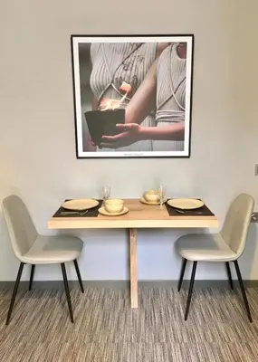 a table with two chairs and a picture on the wall at Metis Athens Suites in Athens