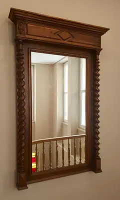 a mirror hanging on a wall next to a staircase at Metis Athens Suites in Athens