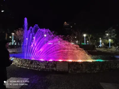 a fountain with pink lights in a park at night at ATHENS RIVIERA SEA VIEW APARTMENT in Piraeus