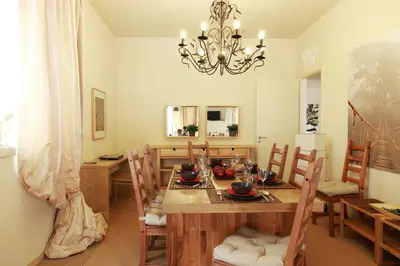 a dining room with a table with chairs and a chandelier at Dream Penthouse in Athens - Kolonaki in Athens