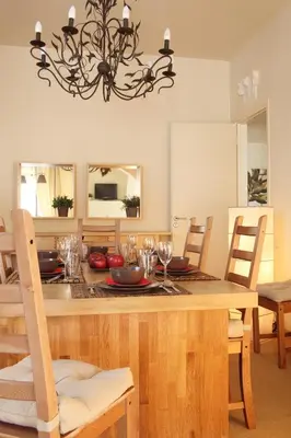 a dining room with a wooden table with a chandelier at Dream Penthouse in Athens - Kolonaki in Athens