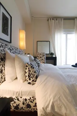a bedroom with a white bed with pillows and a window at Dream Penthouse in Athens - Kolonaki in Athens
