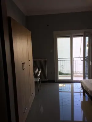 a room with a bedroom with a large window at Joges 2 in Athens