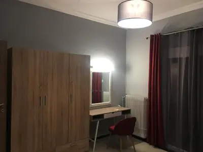 a room with a desk and a mirror and a red chair at Joges 2 in Athens