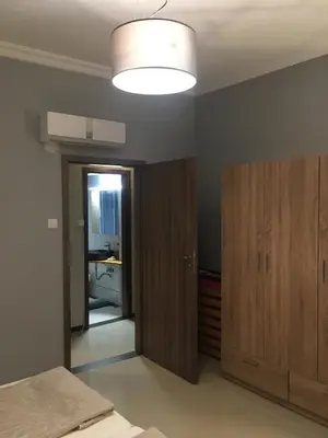 a room with a bed and a door and a lamp at Joges 2 in Athens