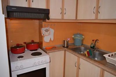 a kitchen with two pots on a stove and a sink at Mary's House Apartment 10 min from Athens Airport in Markopoulo