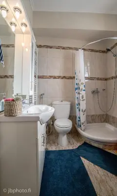 a bathroom with a toilet and a sink and a tub at Mary's House Apartment 10 min from Athens Airport in Markopoulo