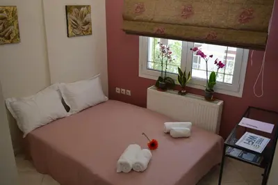 a bedroom with a bed with towels on it at Mary's House Apartment 10 min from Athens Airport in Markopoulo