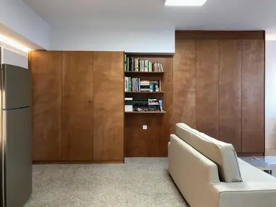 a living room with a couch and a book shelf at Majestic City Hall in Athens