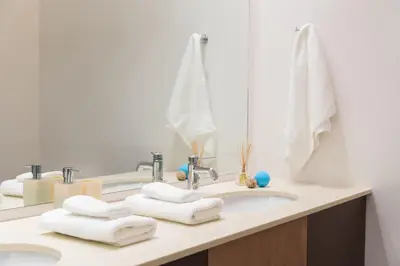 a bathroom with two sinks with towels at Majestic City Hall in Athens