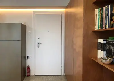 a white door in a kitchen with a refrigerator at Majestic City Hall in Athens