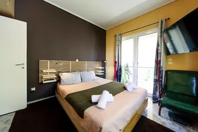 a bedroom with a bed with two white towels on it at warm cozy & quiet in Athens