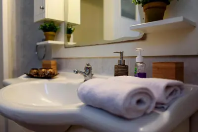 a towel sitting on a sink in a bathroom at warm cozy & quiet in Athens