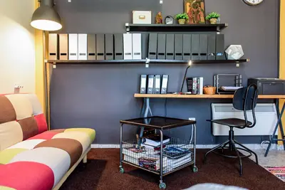 a room with a couch and a desk and a chair at warm cozy & quiet in Athens