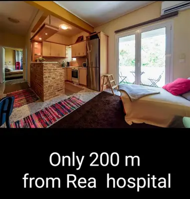 a room with a bed and a kitchen at warm cozy & quiet in Athens