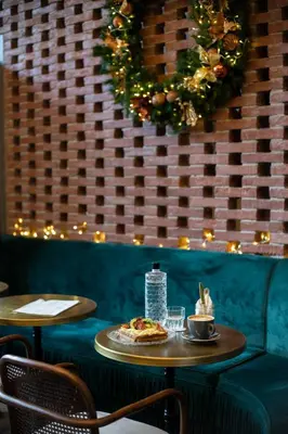 a table with a pizza on it in a restaurant at PAME House in Athens