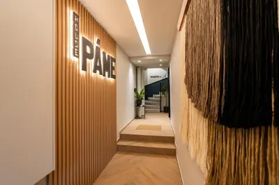 a hallway with aporate sign on a wall at PAME House in Athens