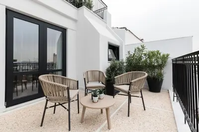 a patio with three chairs and a table at Oniro City in Athens