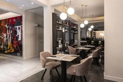 a restaurant with tables and chairs and a bar at Oniro City in Athens