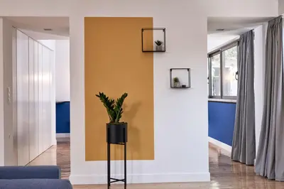 a living room with a blue and yellow wall at MONO Lofts in Athens