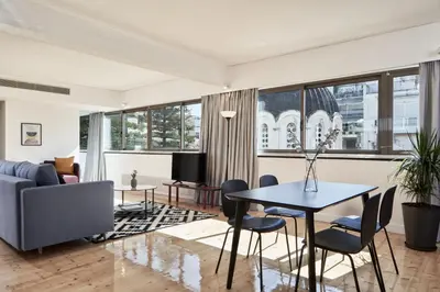 a living room with a table and chairs and a couch at MONO Lofts in Athens